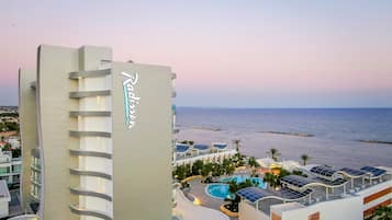 Enjoy the rooftop pool surrounded by palm trees and take in the stunning sea views.