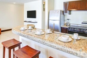 Enjoy cooking in this fully equipped kitchen with a refrigerator, oven, and microwave.