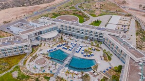 A modern hotel with a central courtyard, two swimming pools, and a landscaped outdoor area. - Hyatt Regency Taghazout  (Taghazout)