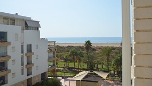 A modern building with multiple balconies overlooking a beach. - Espigón Central 11 - One Bedroom Apartment, Sleeps 3 (Punta del moral)