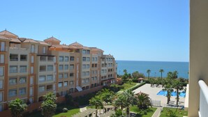 A multi-story hotel with balconies, a swimming pool, and a view of the sea. - LAS ARENAS 235 - Two Bedroom Apartment, Sleeps 5 (Punta del moral)