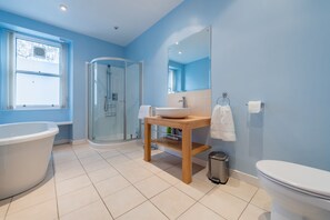 Bathtub, hair dryer, slippers, towels