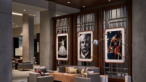 A modern lobby with a sofa set, a coffee table, and framed artwork on the wall. - Marriott Owings Mills Metro Centre (Owings Mills)