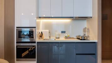 A modern kitchen with stainless steel appliances, a built-in oven, and a sink.