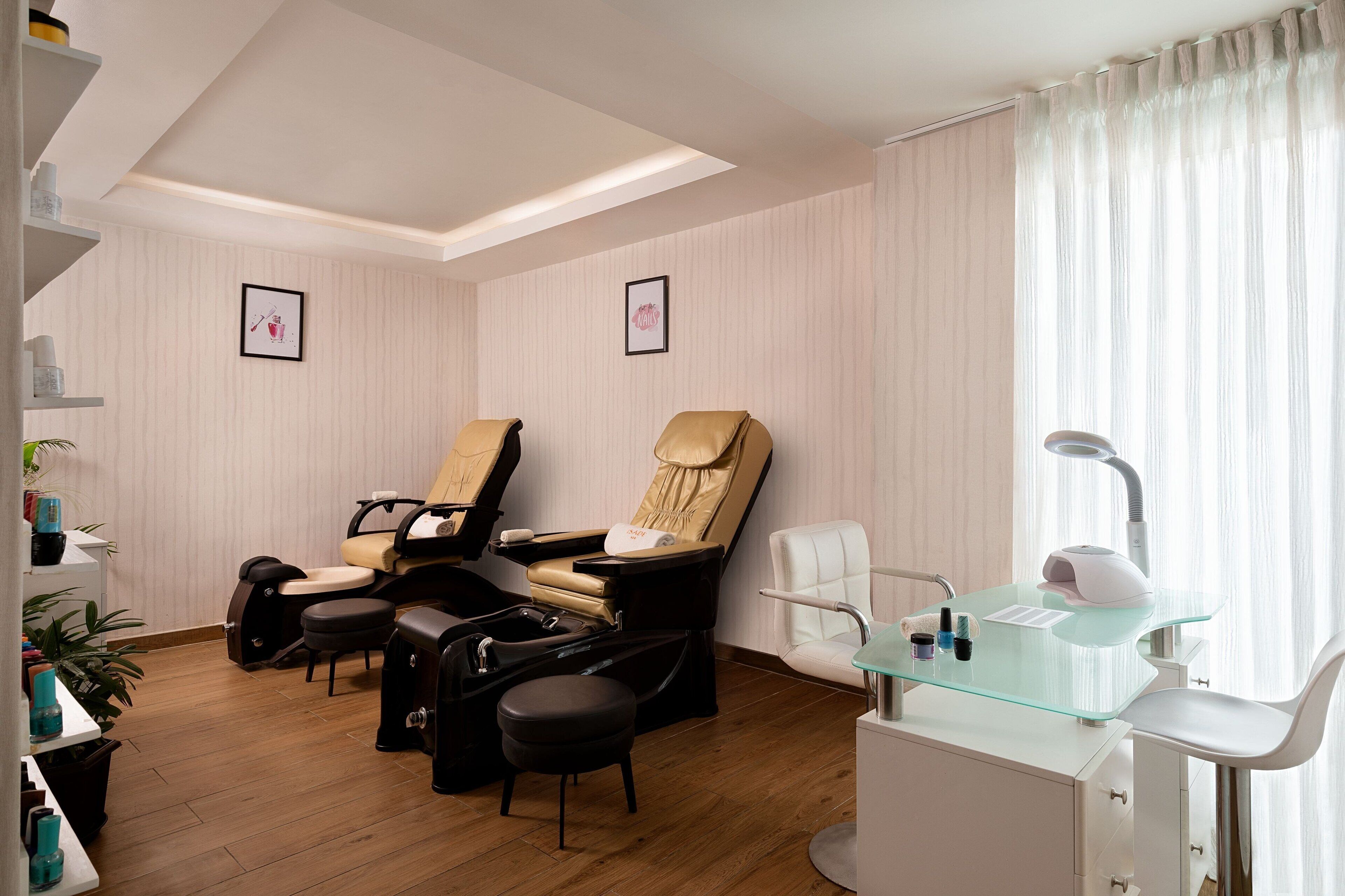 A modern room with a massage chair, a hairdryer, and a glass table.