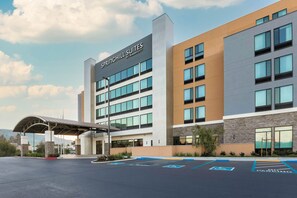 A modern hotel with a clear sign reading "Springhill Suites by Marriott" and a covered entrance. - SpringHill Suites by Marriott San Jose Fremont (Fremont)