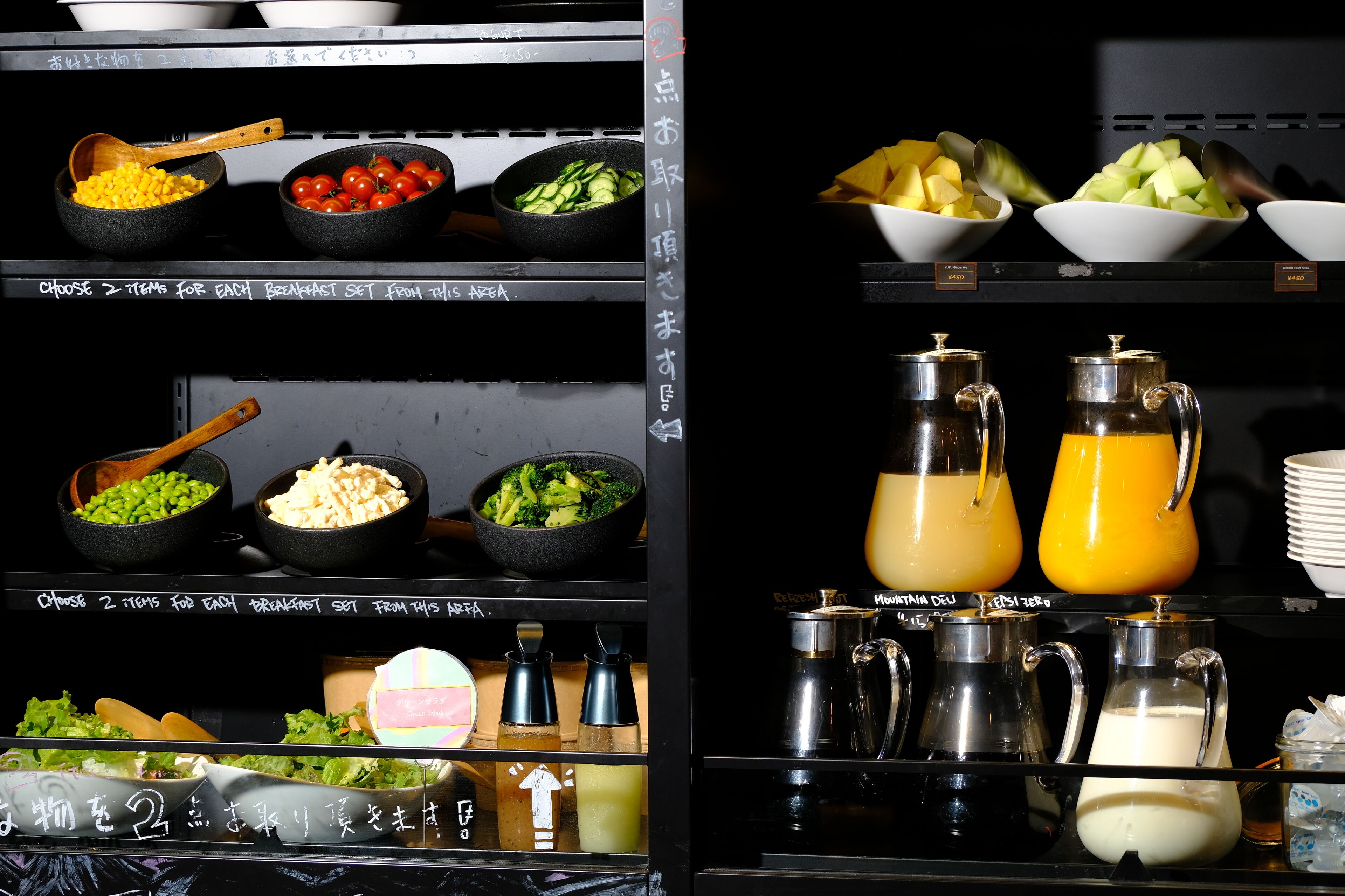A buffet with various food items and beverages.
