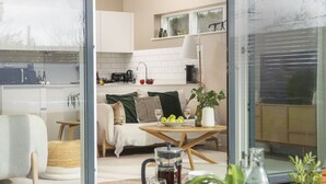 A modern kitchen with white cabinets, a microwave, and a coffee maker. - Footsteps to the dunes - Hot Tub - Pet friendly (Hayle)
