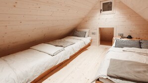 A cozy attic bedroom with two single beds, wooden walls, and a small window. - Private Cottage - Active Regeneration and Relaxing Hollidays (Stahovica)