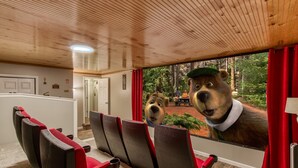 A room with a large window, wooden ceiling, and a view of an outdoor area with greenery. - Rustic River Lodge by HoneyBearCabins (Sevierville)