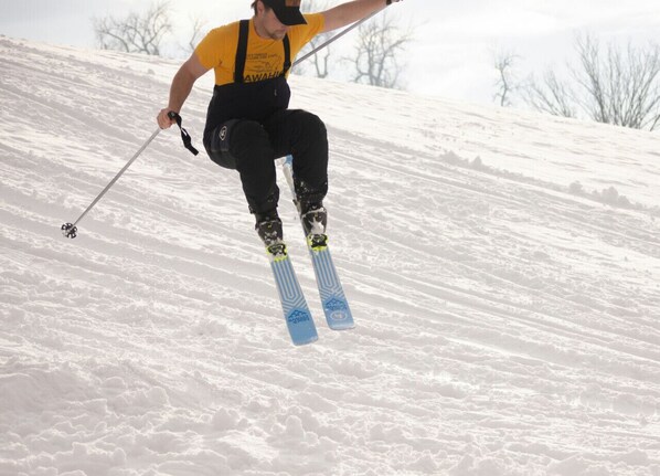 Une personne qui fait du ski sur une pente enneigée.
