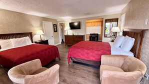 A hotel room with two beds, a TV, a dresser, a desk, and a chair. - Sage N Sand Motel (Moses Lake)