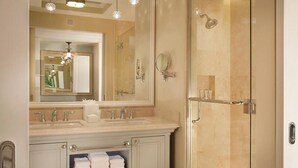 A bathroom with a large mirror, two sinks, a shower, and a towel rack. - EILAN HOTEL & SPA - 1 BR (San Antonio)