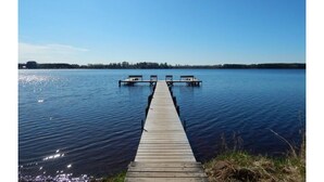 A wooden dock extending into calm water with a clear sky above. - Live Free, See Sofia - Premium Room 2 (Chilkiya)