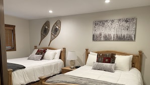 Two wooden beds with white bedding, a wall-mounted artwork, and a window with blinds. - Perfect location off 4 o'clock run, Walk to Mainstreet, Ski-In, Shared Hot Tub (Breckenridge)