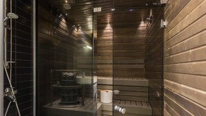 A modern bathroom with a glass shower enclosure, a built-in toilet, and a bidet.