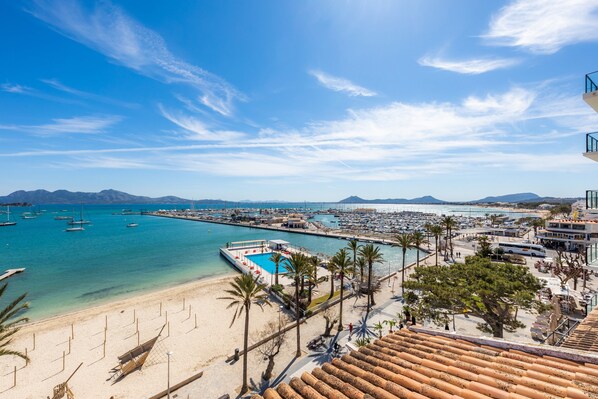 A coastal hotel with a beach, pool, and marina.