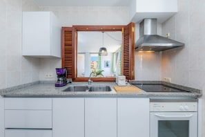 A kitchen with a built-in dishwasher, a coffee maker, and a toaster.