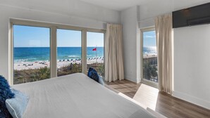 A bedroom with a large bed, multiple windows, and a view of a beach. - Gulf Front Condo w/Stunning Views, Private Beach Access, Gulf Front Pool! Tops'l Beach Resort (Miramar Beach)