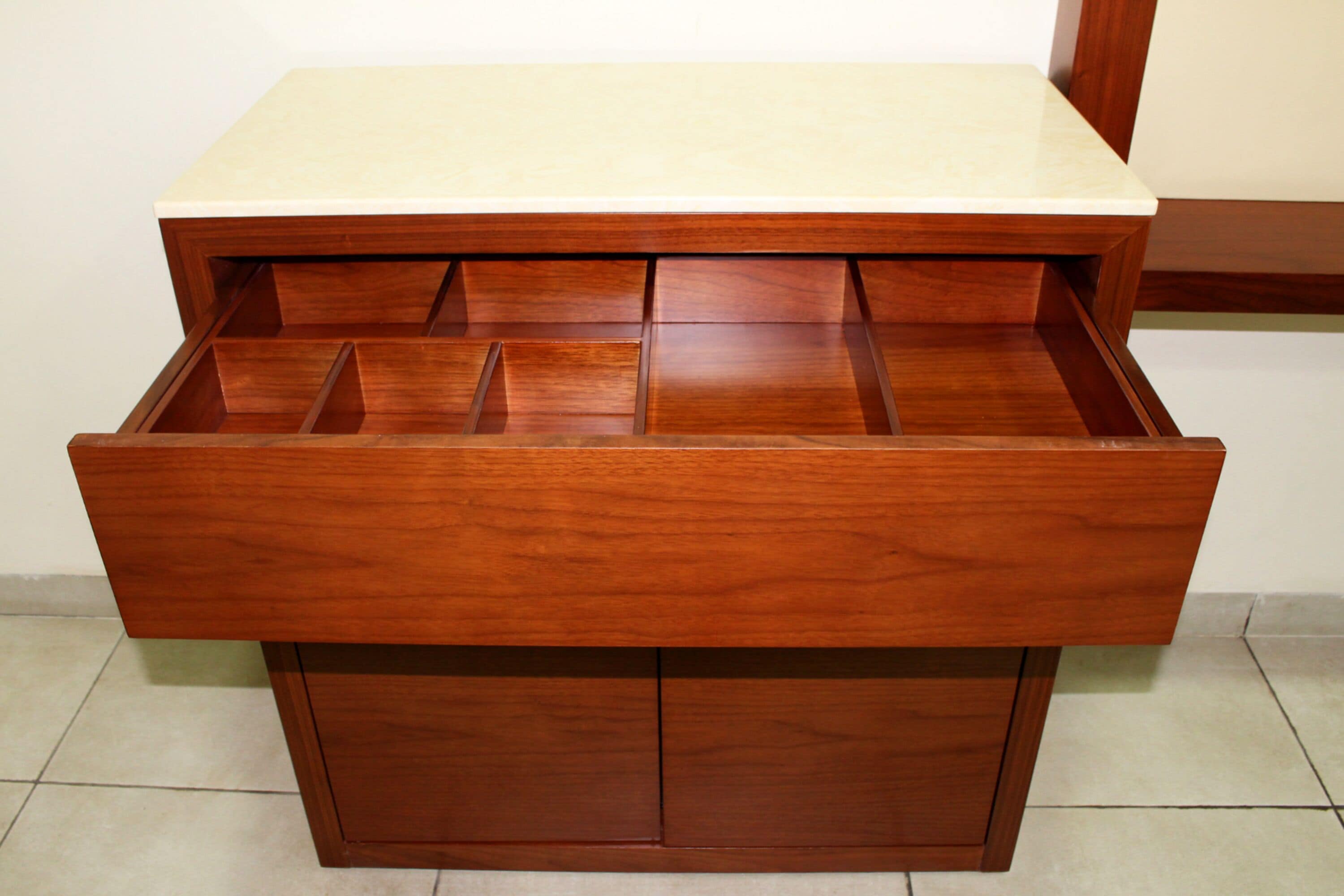 A wooden drawer unit with multiple compartments.