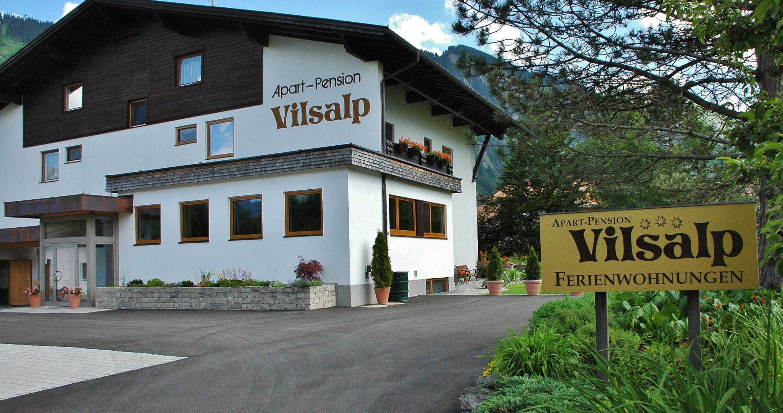 A two-story building with a sign indicating it is an apartment-pension named Vilsalp.
