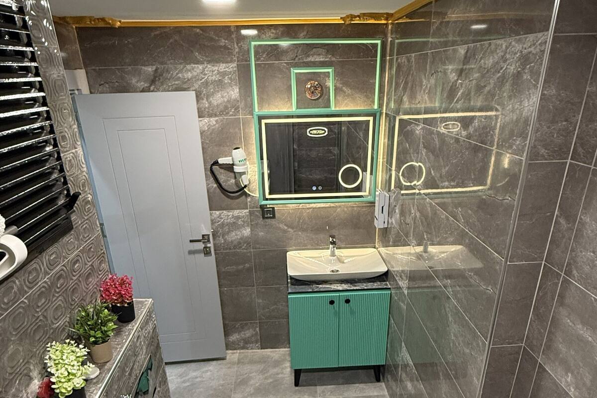 A modern bathroom with a toilet, sink, and shower area.