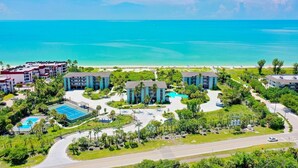 A resort with multiple buildings, a pool, and a beach view. - Tarpon Beach 206: Beautiful Condo & Stunning Gulf Views to Match (Sanibel)