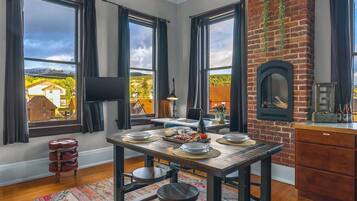 【Living Loft】 14ft cathedral ceilings, original 19th-century brick — your view from the couch