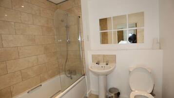 Combined shower/bathtub, towels, toilet paper