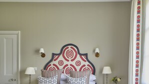 A neatly arranged bedroom with a large bed, bedside tables, and a nightstand. - Cockloft, Romantic Countryside Hideaway (Bishops Cannings)