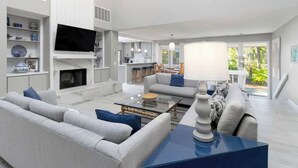 A modern living room with a sofa, coffee table, and TV.