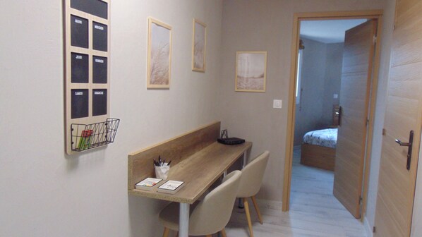 A small, narrow room with a wooden desk, two chairs, a bed, and a door leading to another room. - 48 sqm apartment with 4 beds - Beach nearby (Bormes-les-Mimosas)