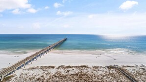 A beach with a long pier extending into the ocean. - Best view on the Gulf! Heated pool and beach gear included! Book today!  (Navarre)