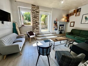 A living room with a sofa, armchair, coffee table, and a fireplace.