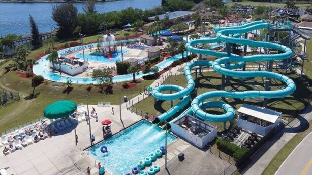 A water park with multiple slides and a swimming pool. - Newly Renovated! Prime Location! Premium bedding! Heated Pool! 3 Br/ 2 Bath (Cape Coral)