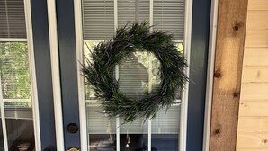 A front door with a wreath, a glass door, and a wooden panel on the right. - Mountain Laurel Cottage ~ Bat Cave North Carolina  RELAX, REFRESH, RENEW! (Hendersonville)