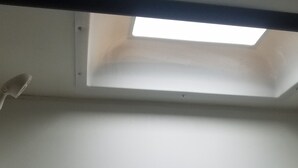 Una habitación con tragaluz y techo blanco.