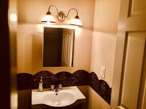 Combined shower/bathtub, hair dryer, soap, toilet paper