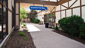 A pathway leading to a building with a sign for "Avalanche Bay Indoor Waterpark." - Ski in on Boyneland Run, Slps 18, Fully remodeled (Boyne Falls)