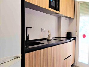 Fridge, microwave, coffee/tea maker, cookware/dishes/utensils