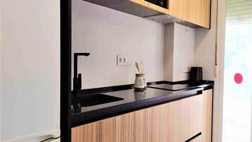 Fridge, microwave, coffee/tea maker, cookware/dishes/utensils