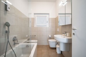 Bathtub, hair dryer, bidet, towels