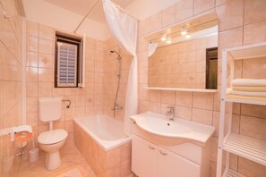 Bathtub, hair dryer, towels