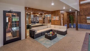 A modern interior with a sectional sofa, a coffee table, and a view into a kitchen area.