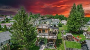 A two-story house with a balcony, surrounded by a suburban neighborhood. - Zen2- Adorable Tiny Home in Davis! Pet Friendly! A/C (Davis)
