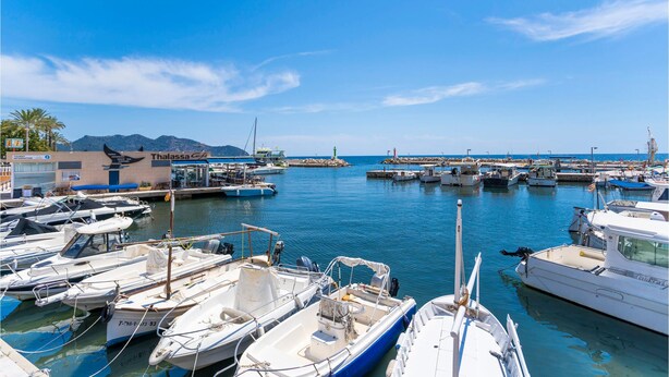 A marina with various boats docked, a building labeled 'Thalassa Café', and a clear blue sky. - Awesome home in Cala Bona (Cala Bona)