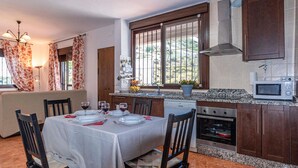 A modern kitchen with granite countertops, a built-in oven, and a microwave. - Gorgeous home in Torrox with WiFi (Torrox)