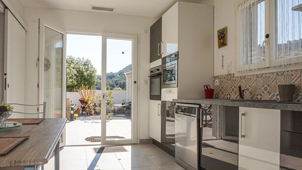 Een moderne keuken met een schuifdeur naar een patio.