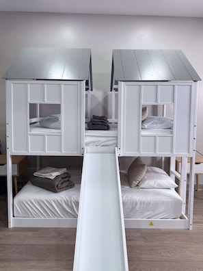 A bunk bed room with a slide connecting the beds. - Displaced Families Ready | Sleeps 10 | Pets OK | EV Charger (Decatur)