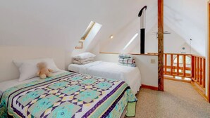 A bedroom with two beds, a large window, and a wooden balcony. - Walk to pond / playground in pet friendly chalet while enjoying mountain views (Madison)